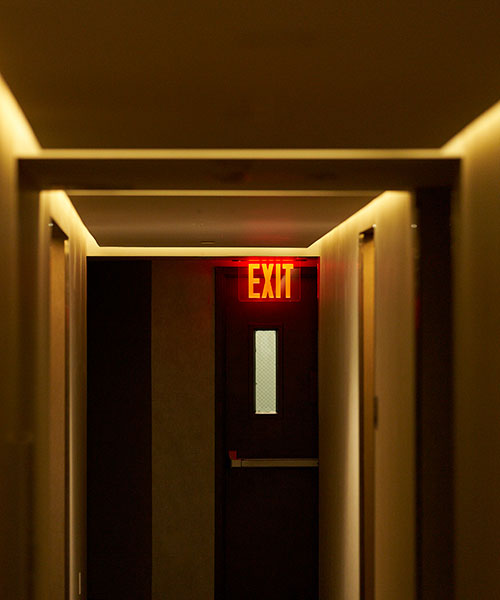 Dimly Lit Hallway With Illuminated Exit Sign And C 2026 03 25 05 54 55 Utc LIFE SAFTY